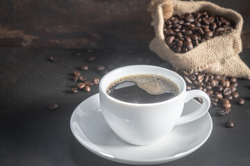 A cup of fresh coffee on rusty metal wall with copy space.