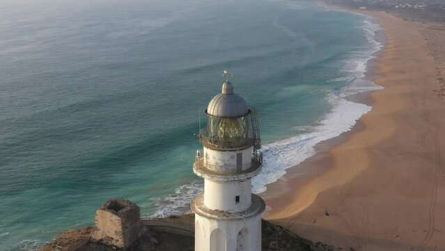 Aerial top view of trafalgar lighthouse in the Atlantic coast of Spain, next to Zahora and Ca&ntilde;os de Meca towns