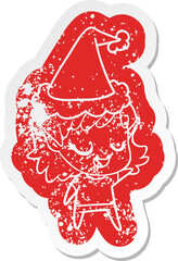 happy cartoon distressed sticker of a elf girl wearing santa hat