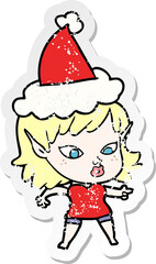 pretty distressed sticker cartoon of a elf girl wearing santa hat