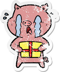 distressed sticker of a crying pig cartoon delivering christmas present