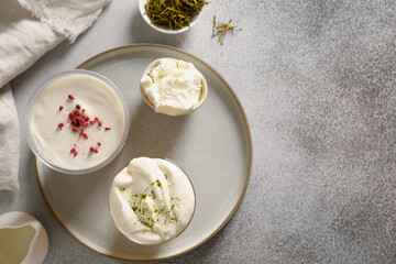 Cheese Tea with creamy foam topped matcha powder and black tea on gray background. Asian trendy oolong and black tea. View from above. Copy space.