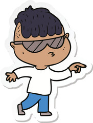 sticker of a cartoon boy wearing sunglasses pointing