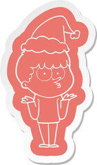 cartoon  sticker of a curious boy shrugging shoulders wearing santa hat