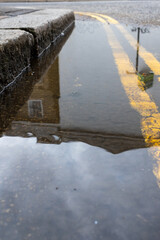 puddle reflections and double yellow lines 