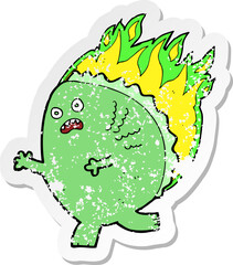 retro distressed sticker of a cartoon monster on fire