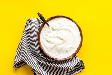 Dairy product - sour cream or yogurt in wooden bowl