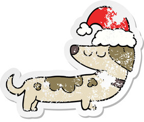 distressed sticker of a cartoon dog wearing christmas hat