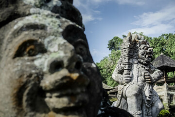 Traditional Balinese statues made of stone carvings in the form of gods, people or demons. Balinese sculpture in temple.