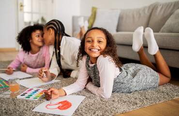 Happy Black Girl Drawing With Mother And Sister Bonding Indoor