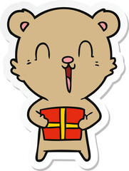sticker of a happy cartoon bear with christmas gift