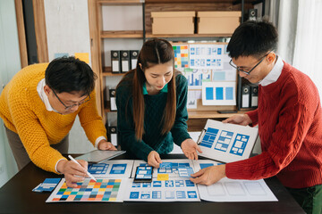 Fototapeta premium Asian businessman and woman people meeting in office. Employee brainstorm and work as team, plan and discuss project by point on paper and tablet. .
