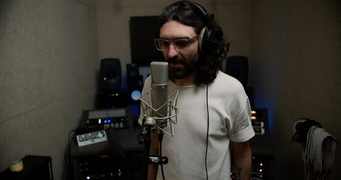 Laying Down the Rhymes: Male Rapper's Energetic Studio Performance