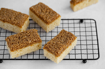 Danish Dream Cake Drømmekage. Sponge cake with coconut and brown sugar topping on a light...