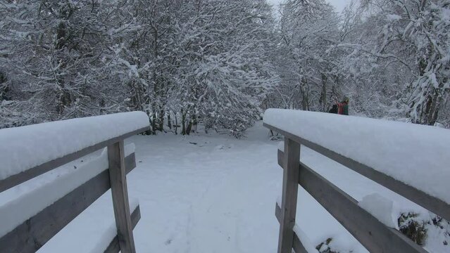 splitboarding winter hike wooden bridge covered snow.