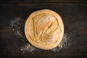 bread on table, freshly baked rustic sourdough bread dusted with powdered sugar