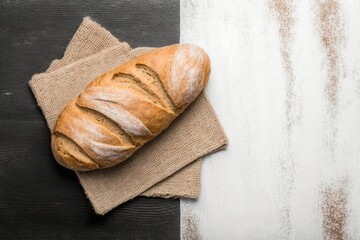 fresh bread on table, perfect bread to accompany your healthy meals on a brown wooden table with part covered in flour