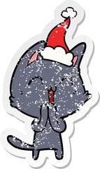 happy distressed sticker cartoon of a cat wearing santa hat