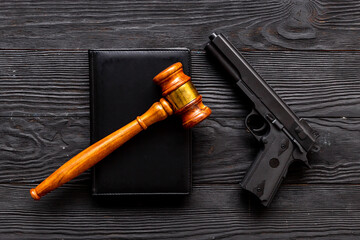 Gun law concept. Hand gun weapon and judges gavel. Crime background