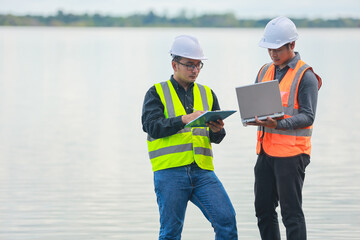 Obraz premium Environmental engineers work at water source to check for contaminants in water sources and analysing water test results for reuse.World environment day concept.