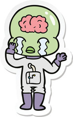 sticker of a cartoon big brain alien crying