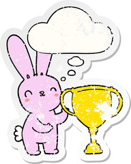 cute cartoon rabbit with sports trophy cup and thought bubble as a distressed worn sticker
