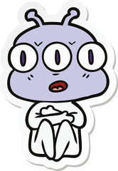 sticker of a cartoon three eyed alien