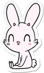Obraz na płótnie Canvas sticker of a cute cartoon rabbit sitting