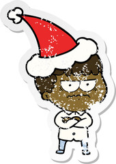 distressed sticker cartoon of an annoyed man wearing santa hat
