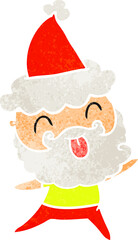 man with beard sticking out tongue wearing santa hat