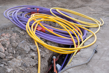 underground electric cable infrastructure installation. Construction site with A lot of communication Cables protected in tubes. electric and high-speed Internet Network cables are buried underground 