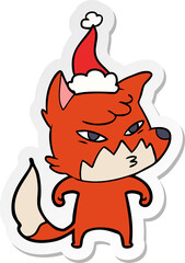 clever sticker cartoon of a fox wearing santa hat