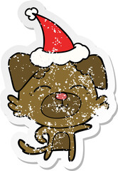 distressed sticker cartoon of a dog pointing wearing santa hat