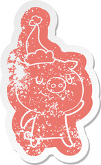 happy cartoon distressed sticker of a pig wearing santa hat