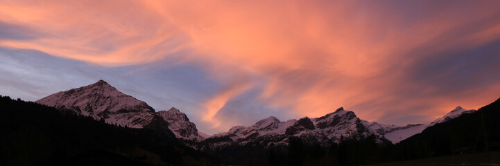 Colorful morning sky over a mountain range in Gsteig Bei Gstaad.