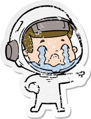 distressed sticker of a cartoon crying astronaut