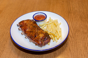 BBQ ribs with french fries and ketchup