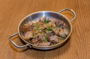 fried meat with onions and greens