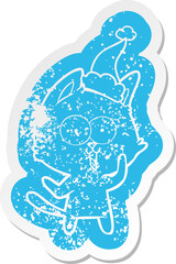 funny cartoon distressed sticker of a cat wearing santa hat