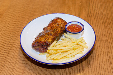 BBQ ribs with french fries and ketchup