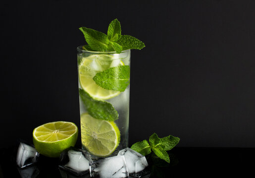 Mojito cocktail in the drinking glass on the black background.Copy space. Close-up.