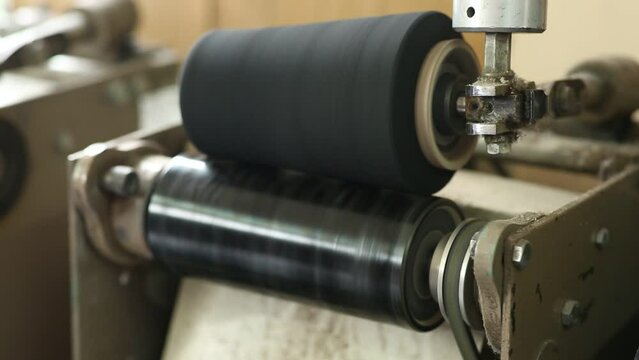 The process of waxing a coil with a thread by rewinding from one bobbin to another using a machine