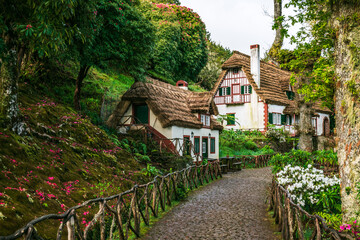 Taditional houses in Queimadas Forest Park in Santana, Madeira near Caldeirao Verde waterfall, Portugal.