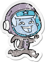 distressed sticker of a cartoon laughing astronaut