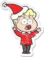 distressed sticker cartoon of a man gasping in surprise wearing santa hat