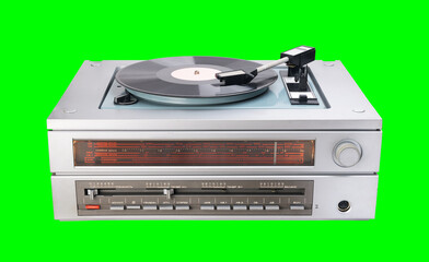 Obraz premium Vintage vinyl player with radio tuner isolated on green background.