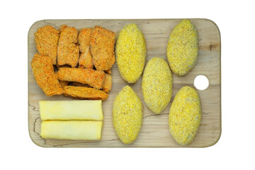Homemade semi-finished products on wooden boardes. Frozen cutlets, pancakes, nuggets. Preparations of homemade food.