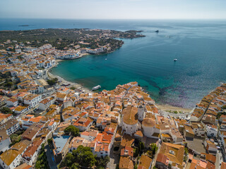 Naklejka premium Aerial images of Cadaqués on the Costa Brava of Girona European tourist town on the border with France Catalonia images of the beach transparent turquoise blue sea