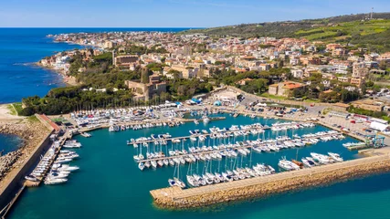 Fotobehang Aerial view of the marina and port of Santa Marinella, in the Metropolitan City of Rome, Italy. In the background the town overlooking the Tyrrhenian Sea. There are many boats moored at the harbour. © Stefano Tammaro