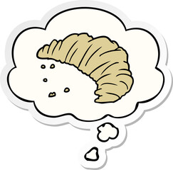 cartoon croissant and thought bubble as a printed sticker